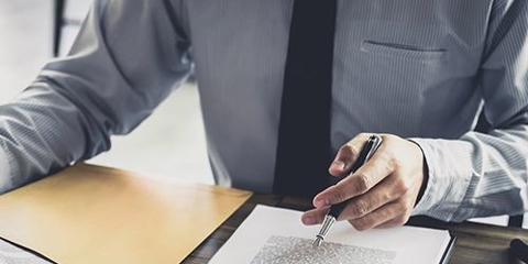 image of two people reviewing a document at a desk