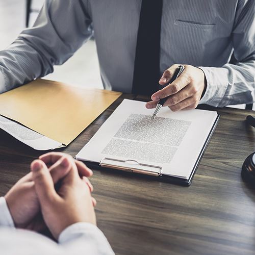 image of two people reviewing a document at a desk